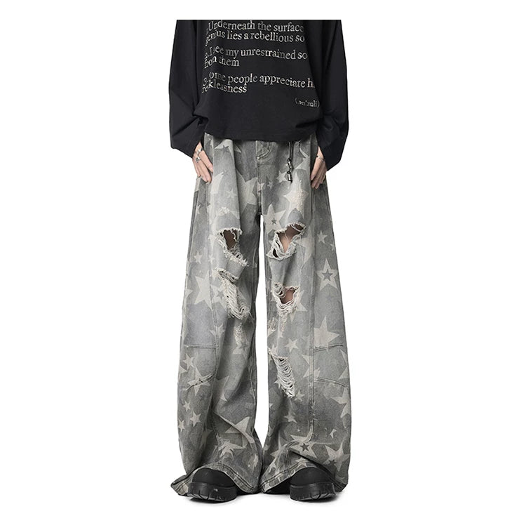 Distressed grey star print wide leg jeans front view featuring shredded thigh and knee rips