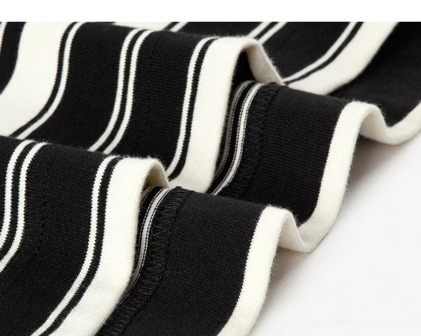 Full product presentation of a 100 percent cotton black and apricot Breton stripe long sleeve streetwear shirt