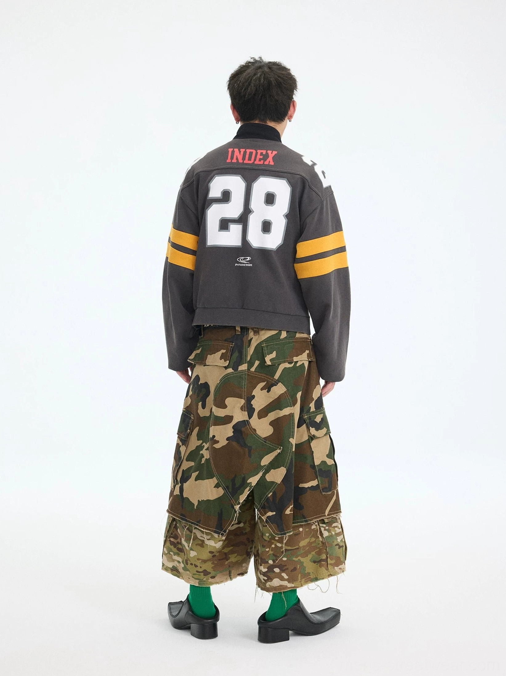 Back view of charcoal gray cropped gridiron jacket featuring red Index lettering oversized white 28 graphic and yellow sleeve stripes