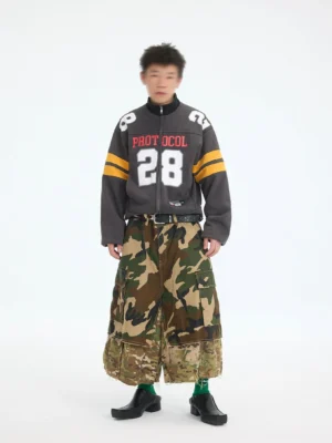 Charcoal gray cropped football zip jacket with Protocol 28 chest graphic and yellow sleeve stripes front full body streetwear outfit