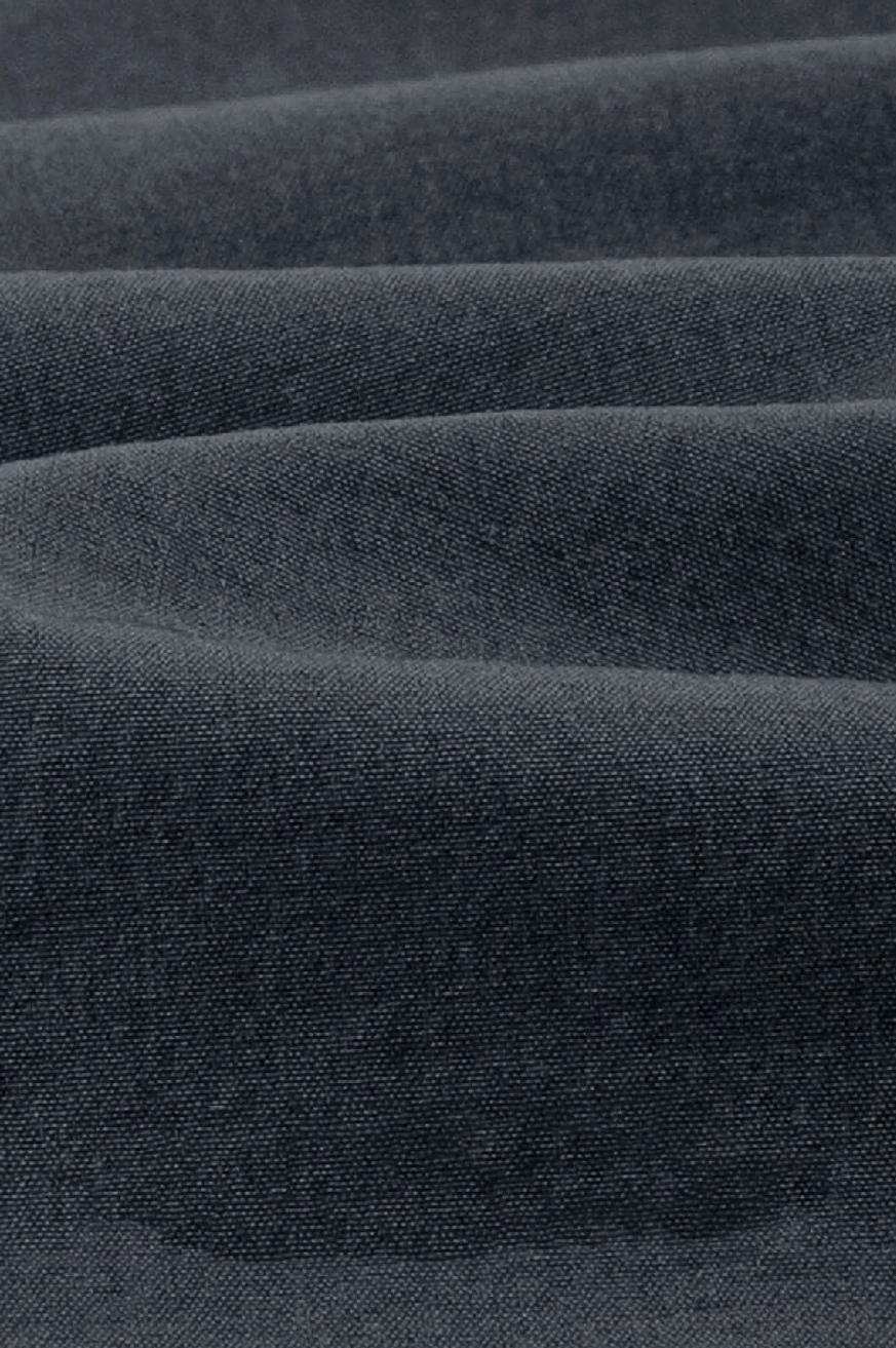 Close-up of dense matte 320GSM cotton fabric texture used for relaxed outdoor tech shorts