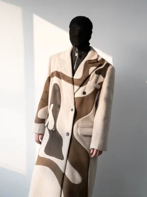 Full length beige abstract patterned double-breasted overcoat in sculptural streetwear styling