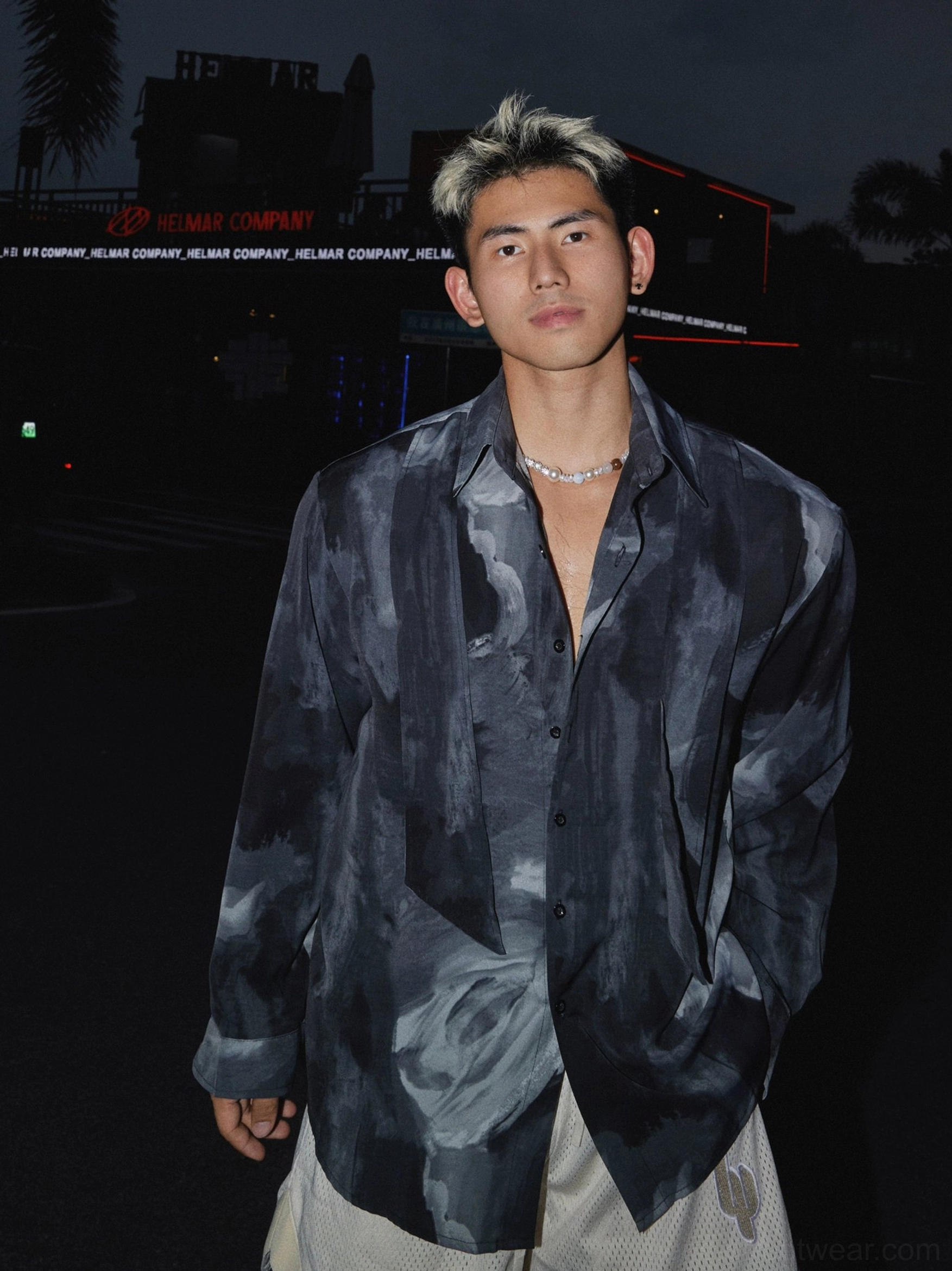 Medium front view of an abstract watercolor printed oversized button-up satin shirt with classic collar and dark tonal streetwear design