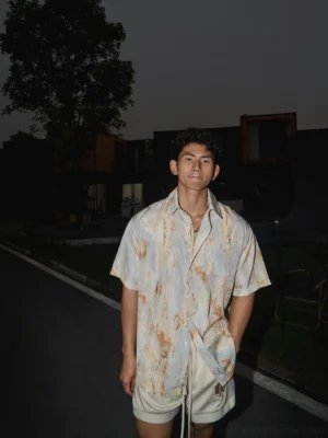Relaxed abstract watercolor print short-sleeve button-down shirt worn with beige drawstring shorts in a casual Seoul-inspired summer streetwear outfit