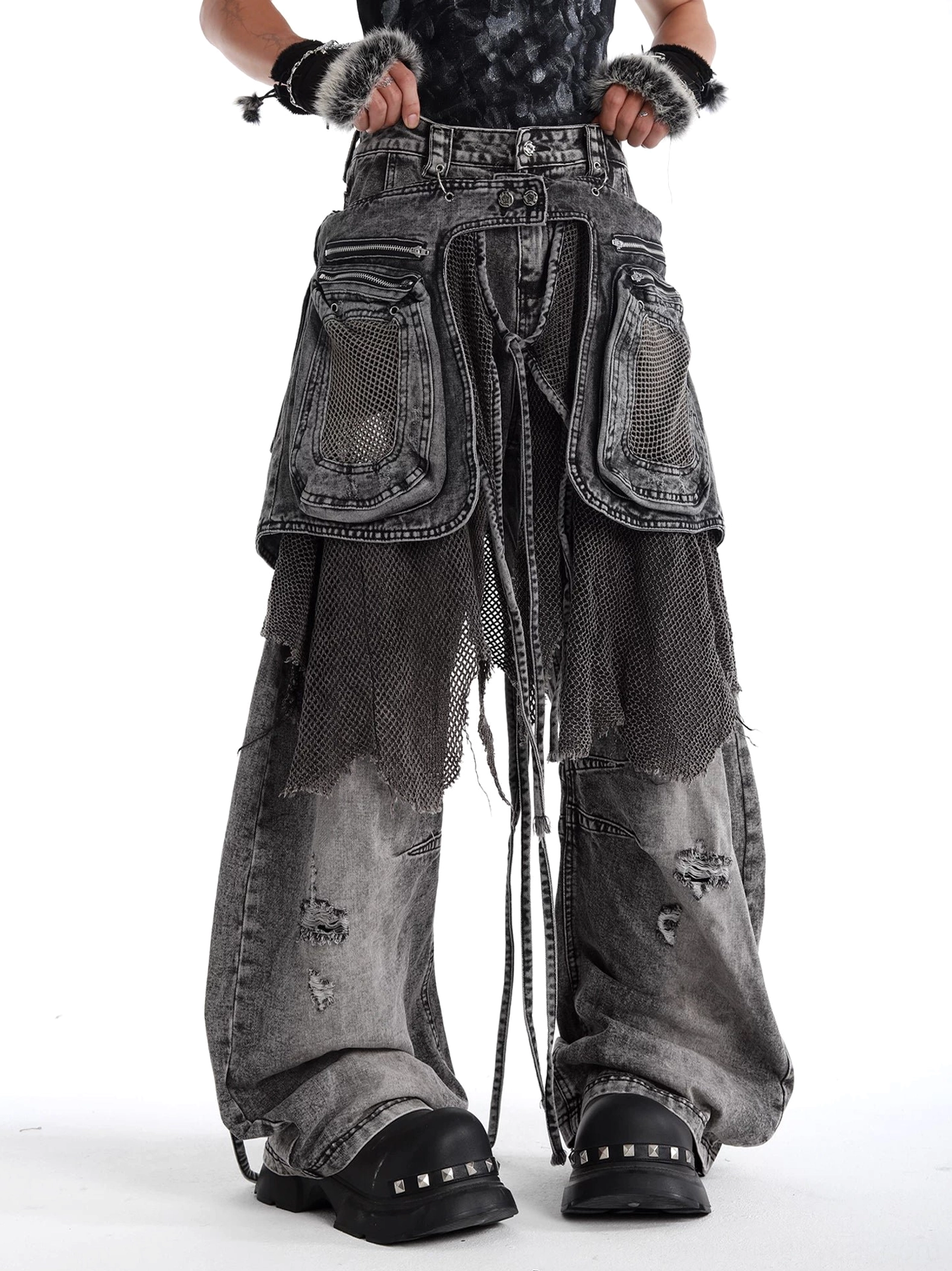 Charcoal ash abyss mesh layered baggy cargo jeans shown in a front three-quarter view with washed distressed denim, oversized pockets, mesh panels, and wide legs
