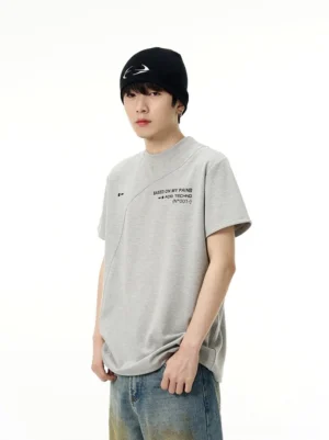 Heather grey Acid Techno graphic T-shirt with relaxed fit, diagonal panel seam, crew neckline, and vintage washed jeans