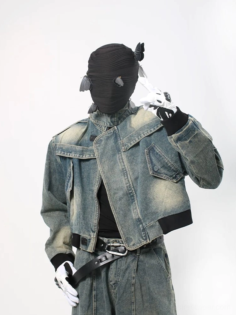 Acid wash cropped denim moto jacket close view with stand collar flap pockets and black ribbed hem