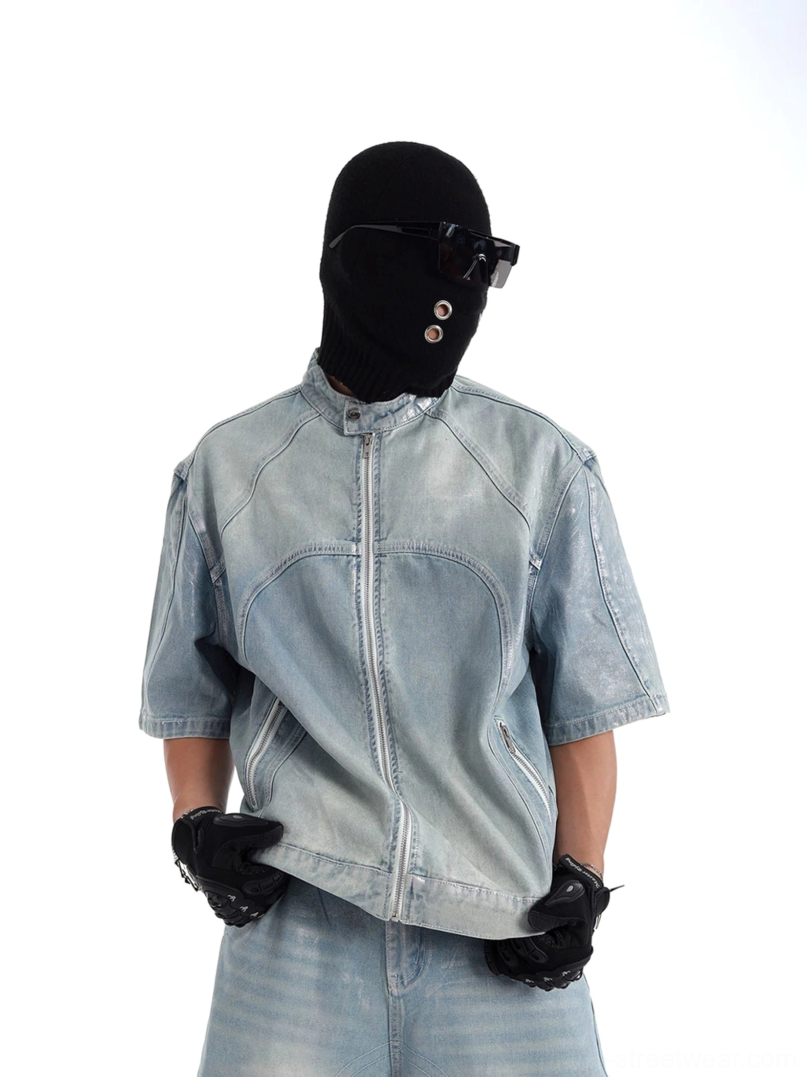 Three-quarter view of relaxed boxy acid wash denim moto jacket with short sleeves, side zip pockets and faded blue streetwear finish
