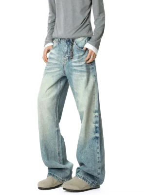 Left three-quarter view of vintage light blue acid-wash super slouch wide-leg jeans with decorative waist chain and oversized stacked streetwear fit