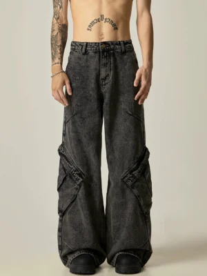 Full front view of acid-washed black cargo wide-leg jeans showing the button-fly waistband, oversized silhouette, and multi-panel utility pocket design
