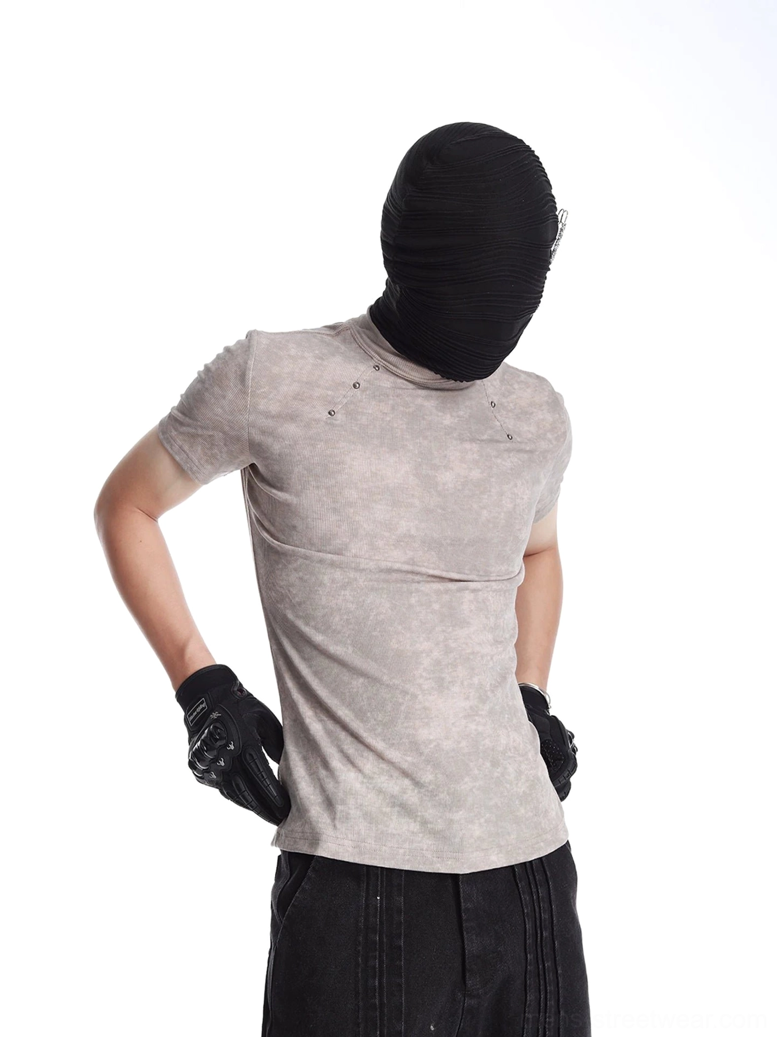 Rear three-quarter view of an acid washed slim fit streetwear T-shirt with metal shoulder accents styled with black wide-leg pants