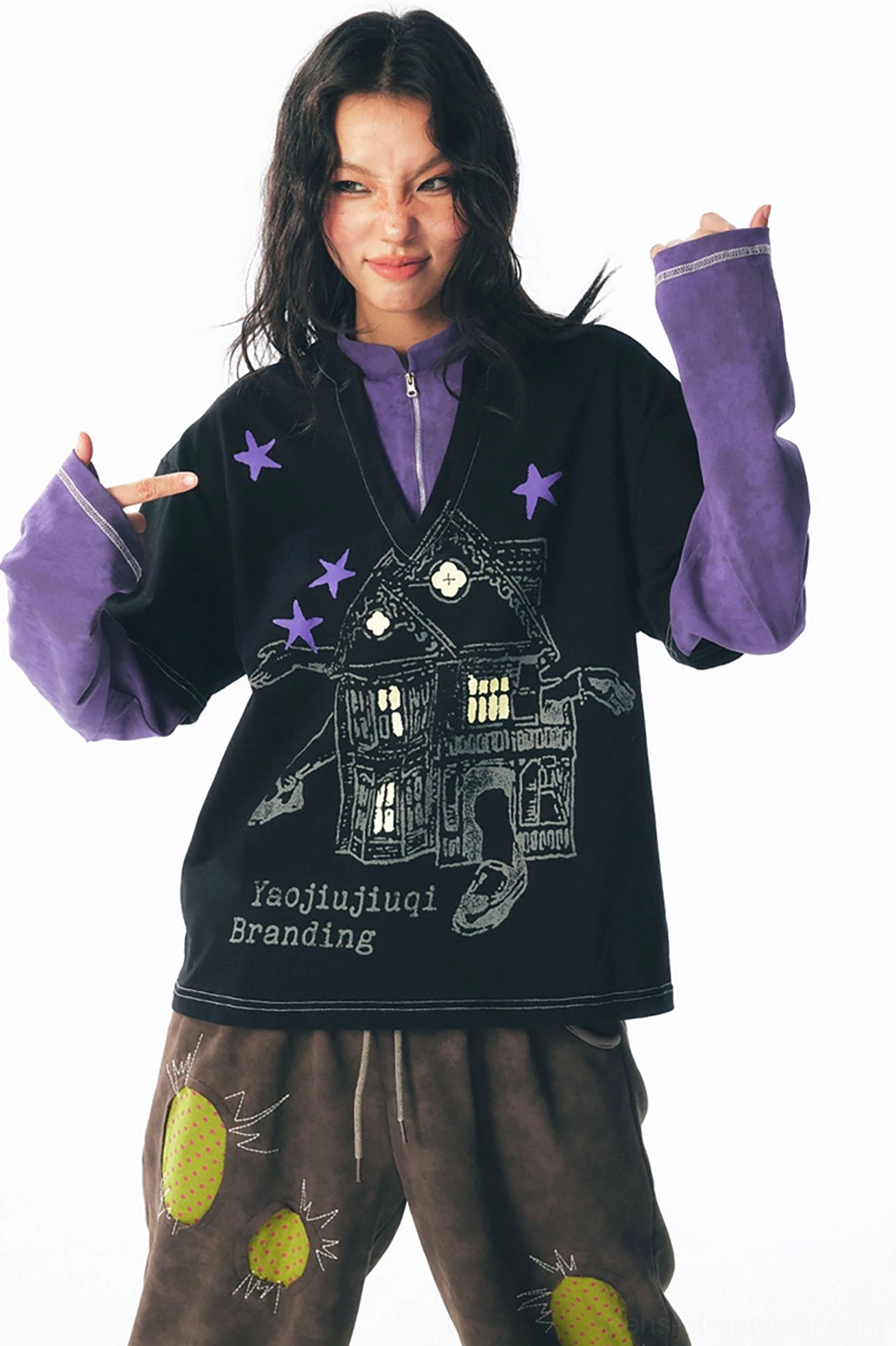 Casual front view of an Acubi-inspired black layered long sleeve tee with purple sleeves, haunted house graphic, and star motifs