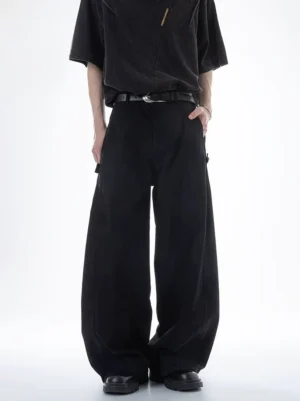 Black Acubi ultra wide-leg cargo pants shown on a male model in a front full-body studio view with a relaxed wide-leg silhouette, high waist, black belt styling, and subtle cargo pockets