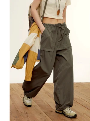 Charcoal gray adjustable wide-leg nylon cargo pants worn in a front full-body Korean streetwear outfit