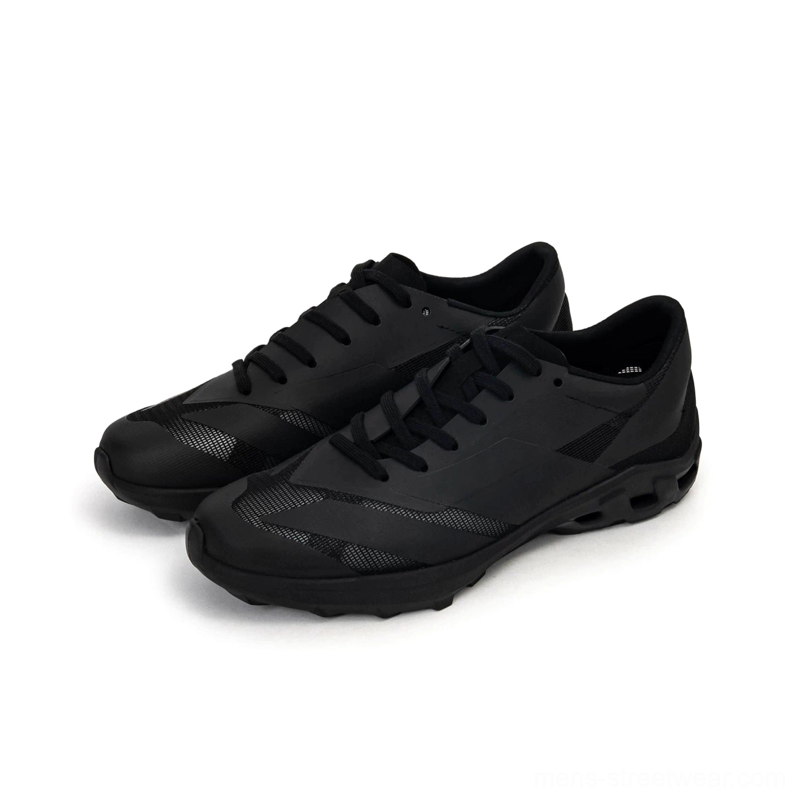 All-black version of chunky trail sneakers displayed from the front on a white studio background with black laces and subtle textured toe panels