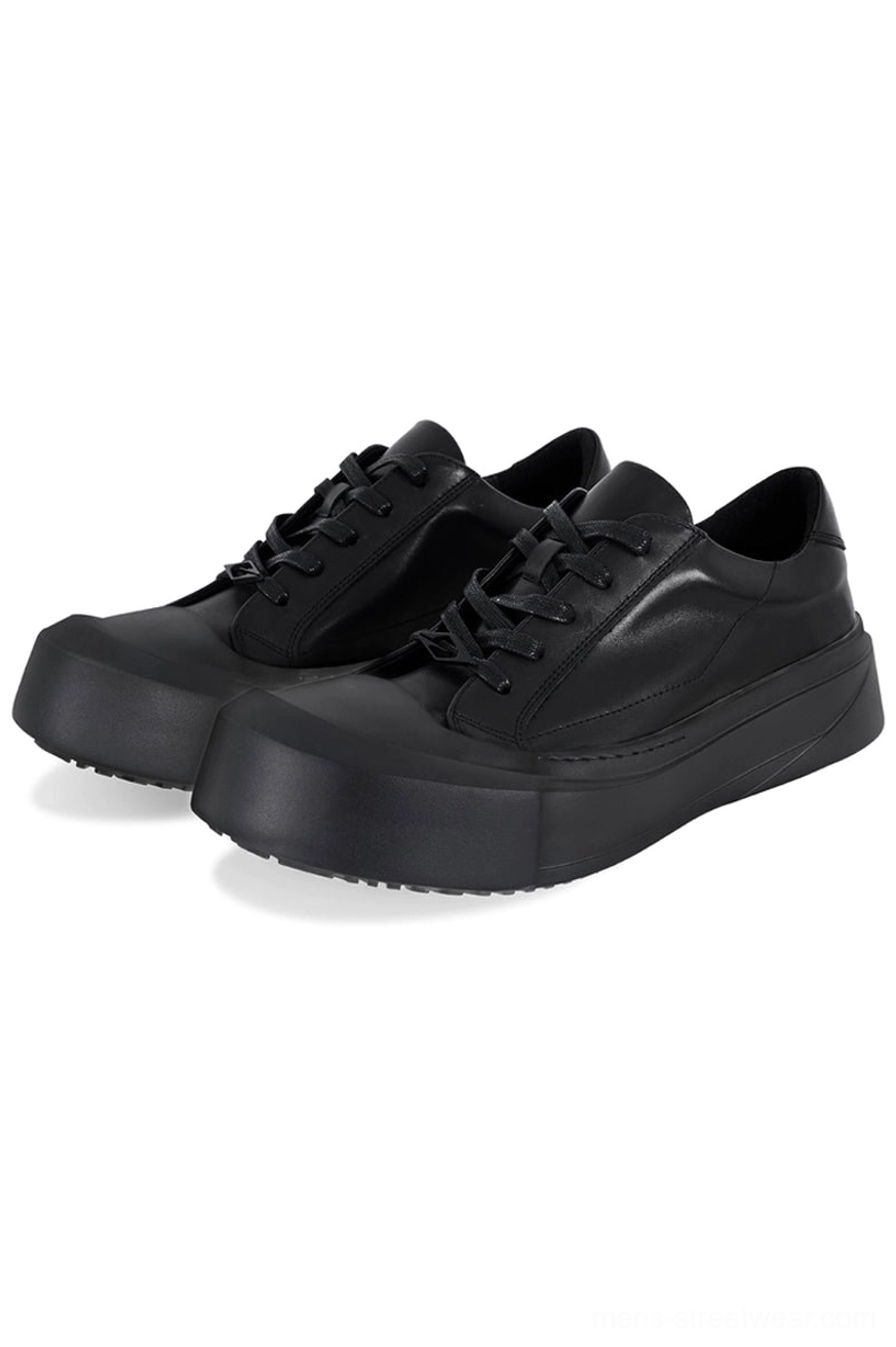 All-black matte leather toe cap platform sneakers with square toe, matching laces, and thick black EVA outsole