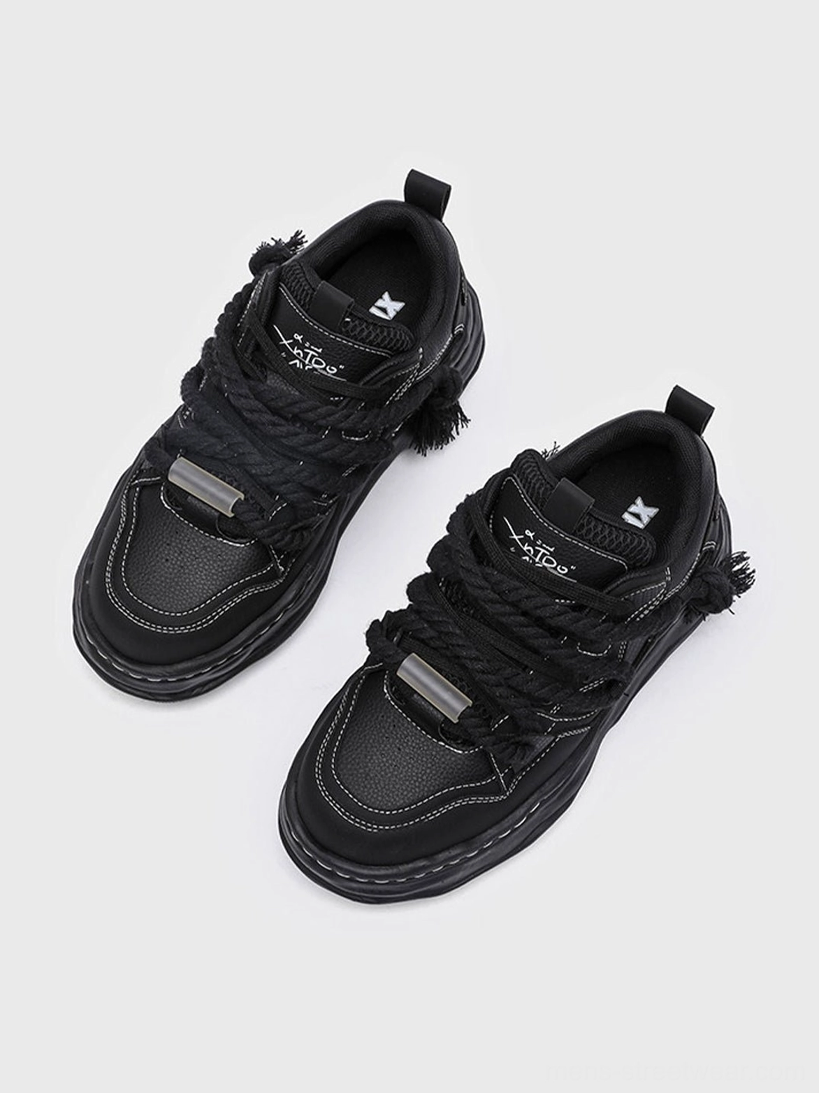 All-black wavy platform sneakers with a sculptural sole and elevated chunky profile for modern avant-garde casual styling