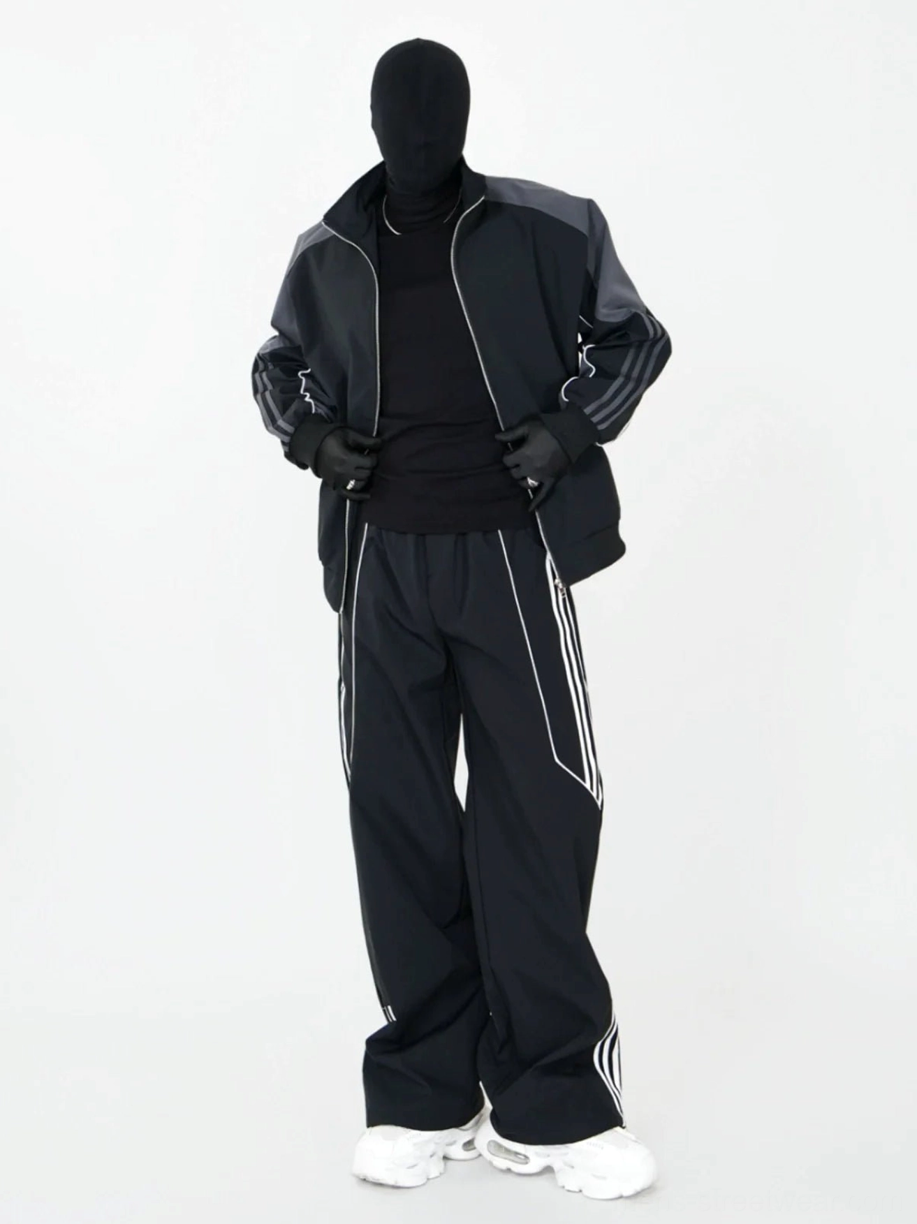 All-black wide-leg triple-stripe track pants styled with a matching athletic zip jacket for a modern Korean streetwear outfit