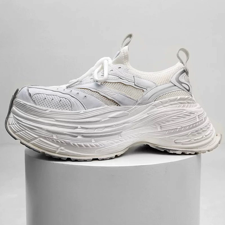 All white minimalist chunky platform sneakers with breathable mesh upper and layered textured sole on display
