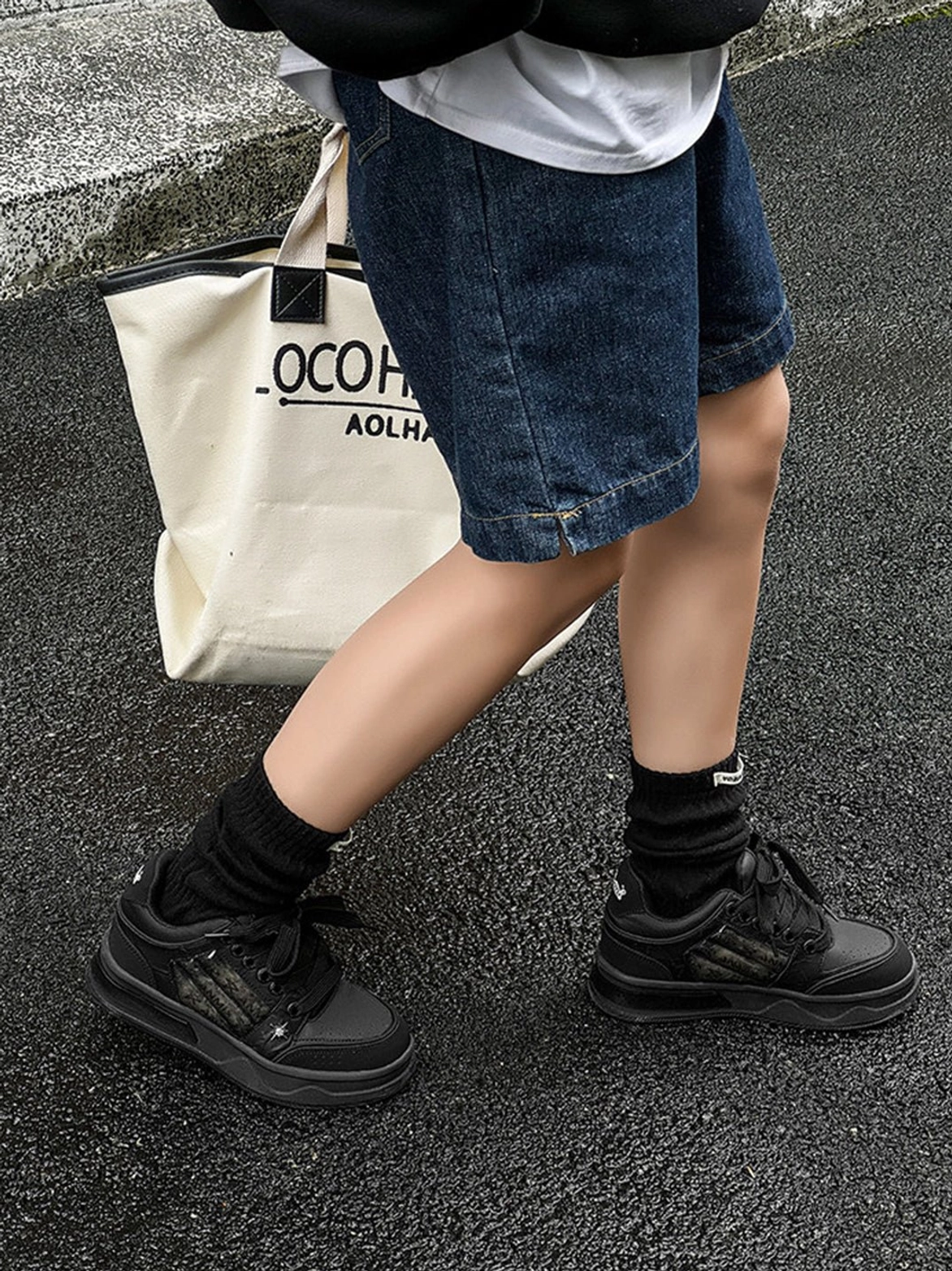 Alternative black streetwear sneakers with star studded detailing, silver side panels, and thick rubber platform soles