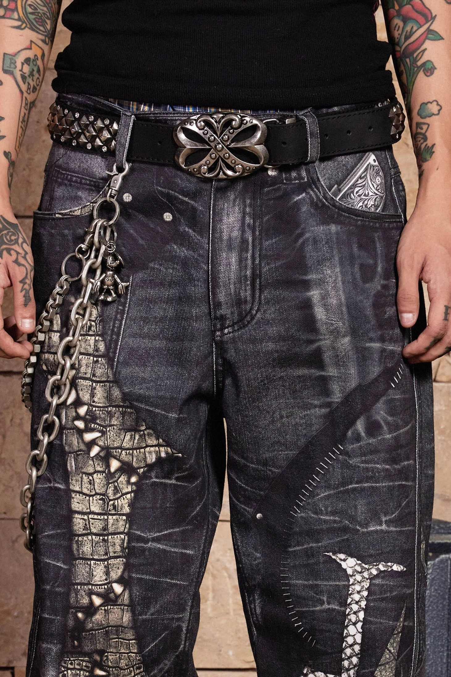 Alternative fashion dragon sword jeans with dark gothic graphics, wide-leg denim construction, studded details, and punk-inspired chain styling