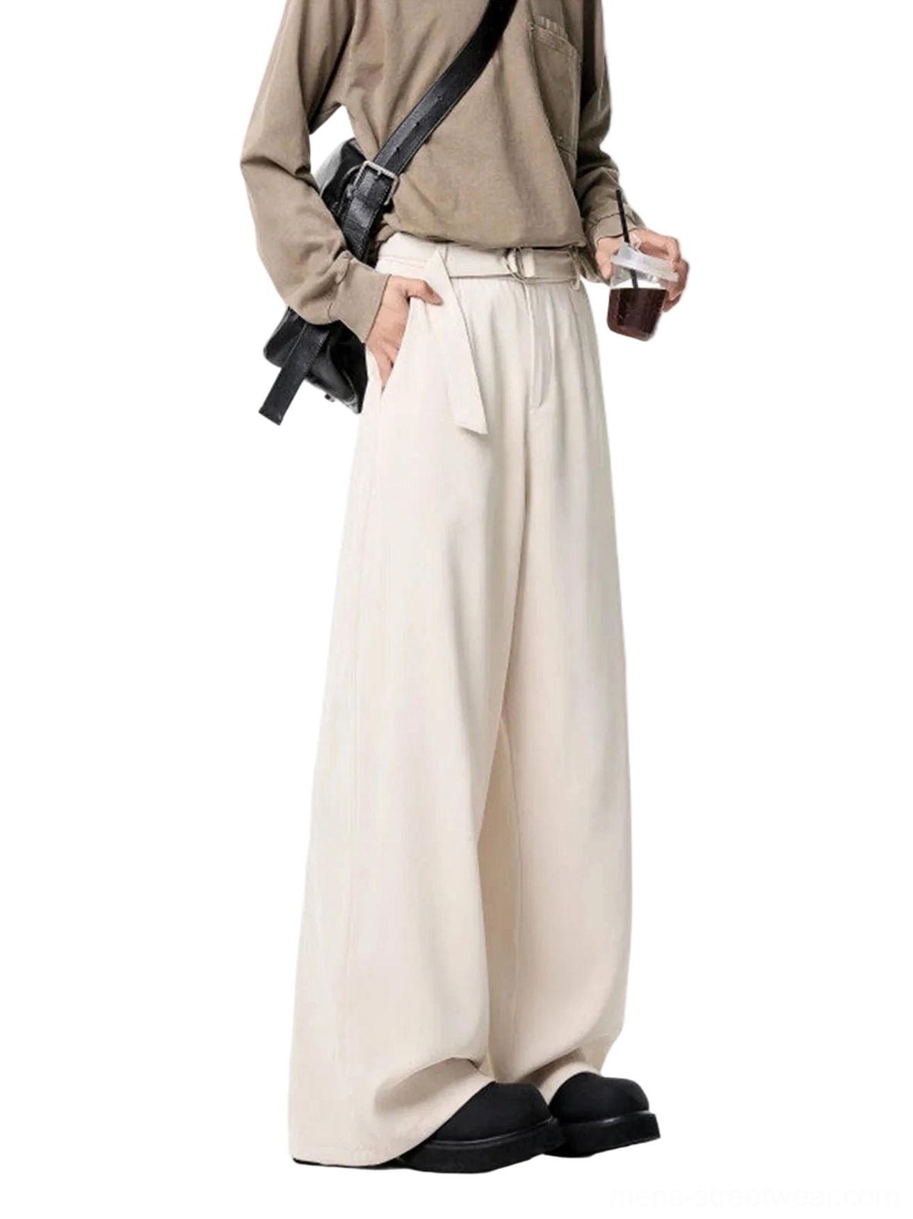 Apricot belted high-waist wide-leg streetwear trousers styled with khaki long-sleeve top, crossbody bag and chunky black loafers