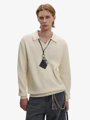 Apricot cream waffle knit Johnny collar polo sweater worn with dark gray wide-leg trousers and chain necklace in Seoul streetwear style