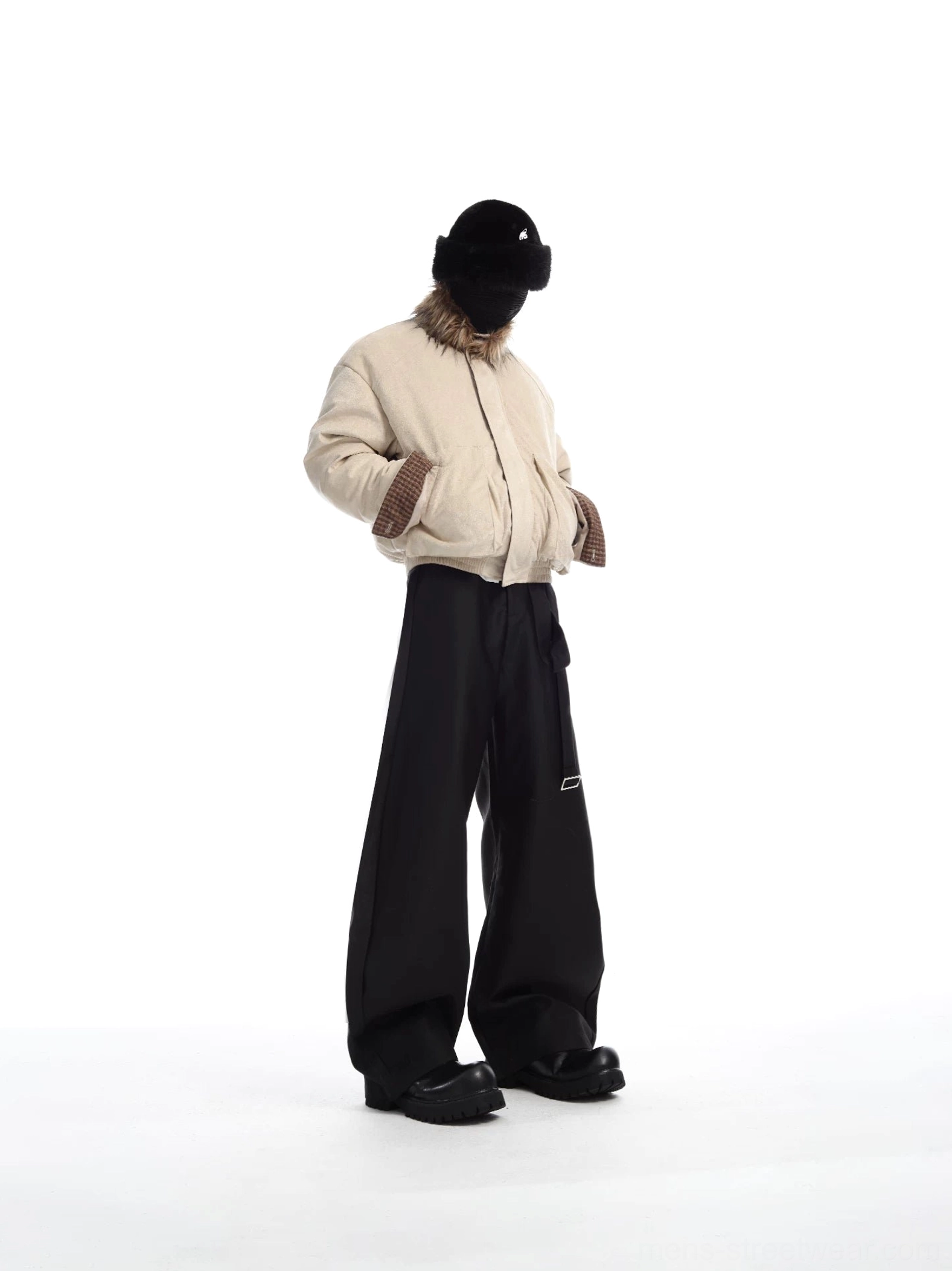 Side view of an apricot cropped faux fur collar bomber jacket with relaxed blouson shape and check-pattern cuff lining