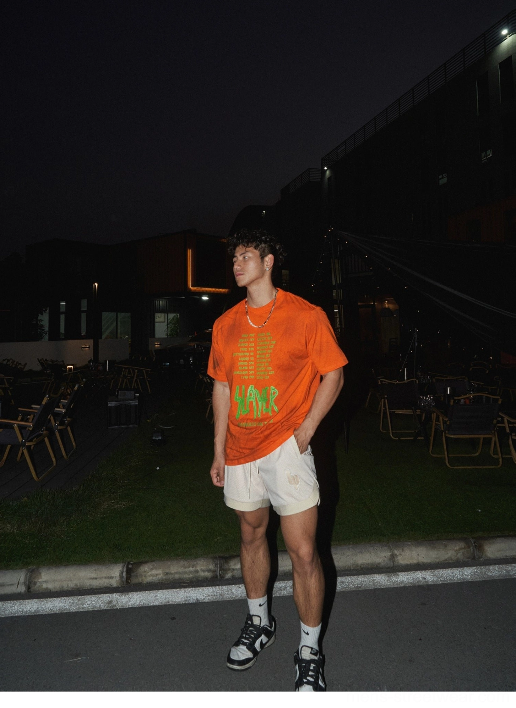 Apricot casual embroidered mesh shorts paired with a bold orange graphic t-shirt for a modern summer streetwear look