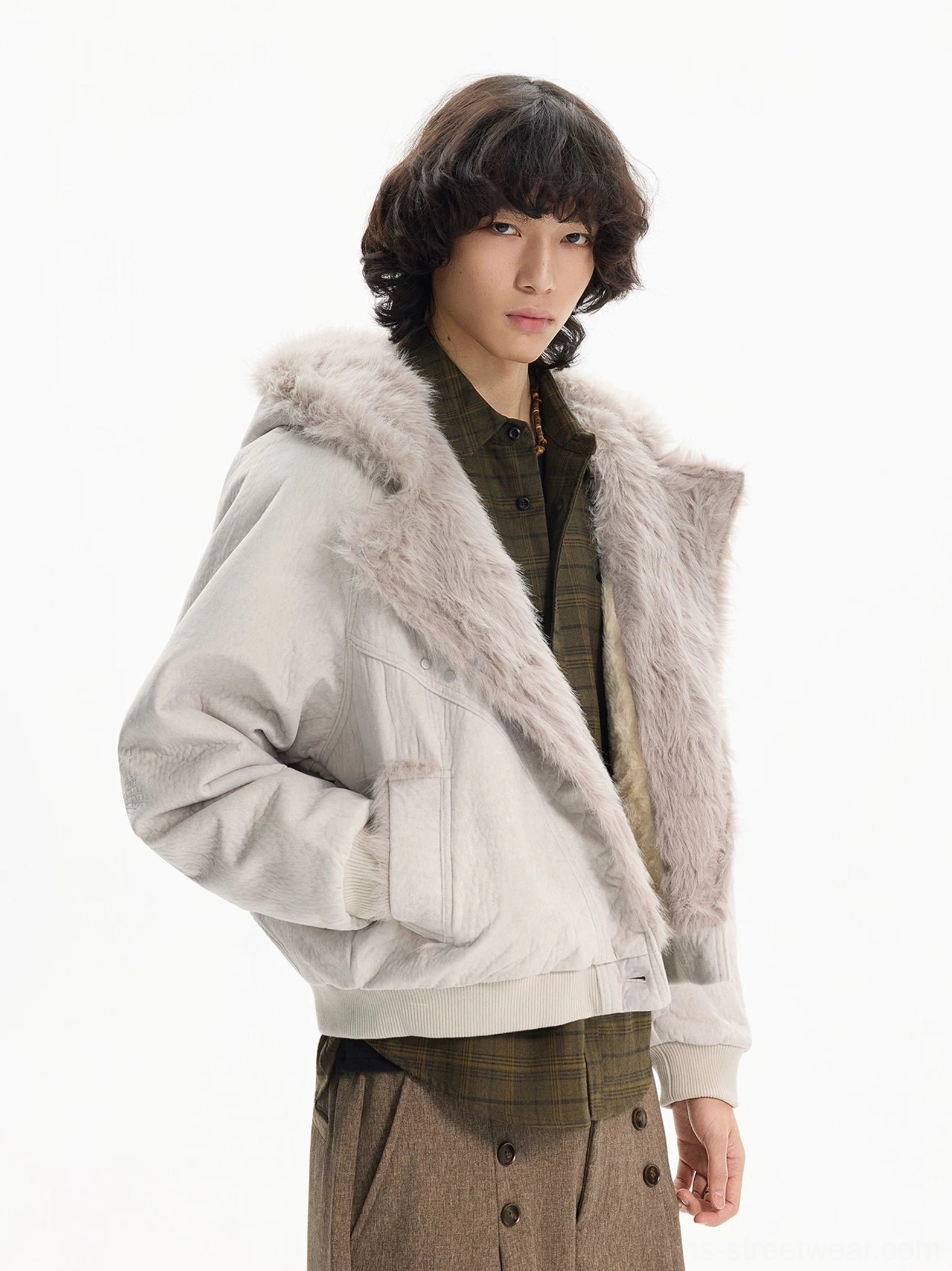 Side view of apricot faux fur lapel bomber jacket with drop shoulders and relaxed cropped streetwear fit
