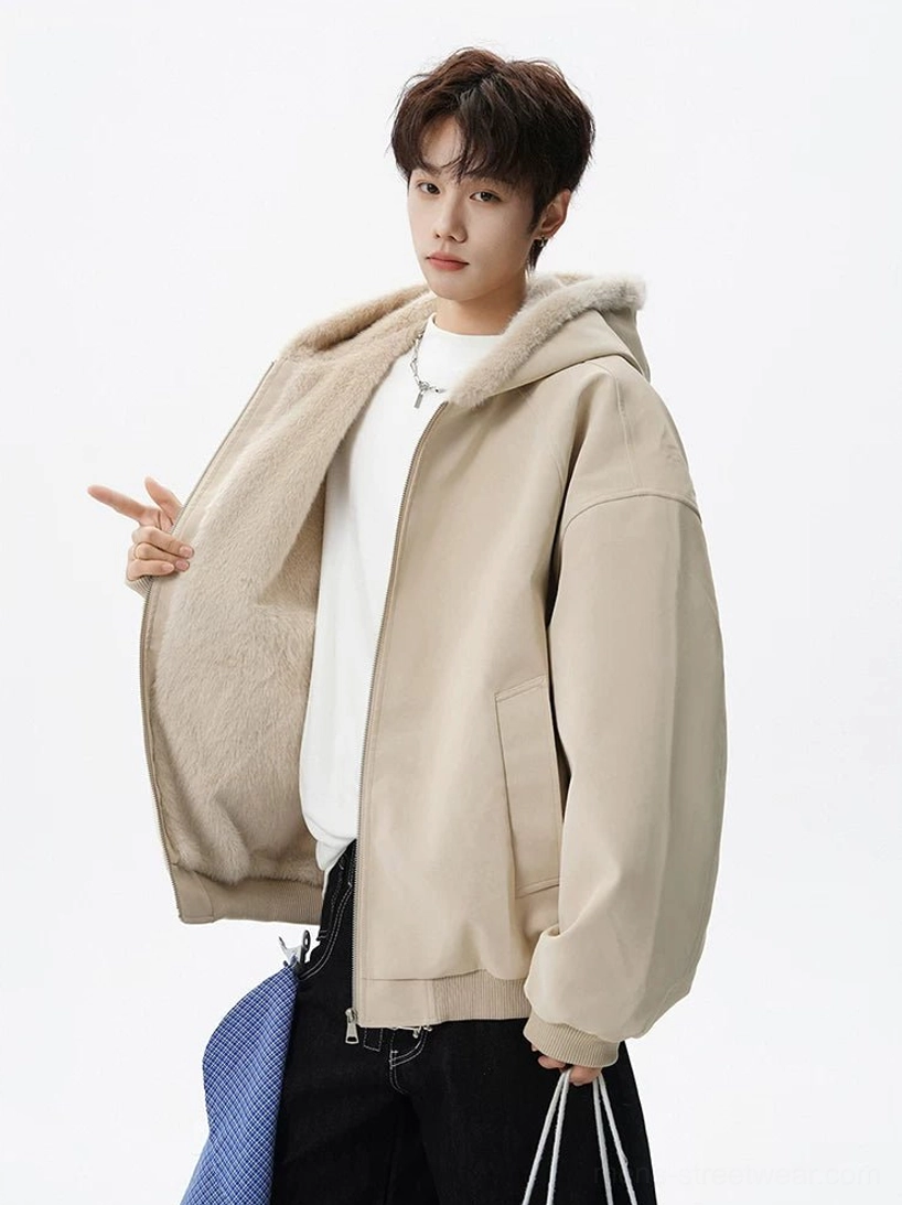 Apricot hooded bomber jacket shown from a three-quarter angle with exposed faux-fur lining, loose sleeves, and side pocket