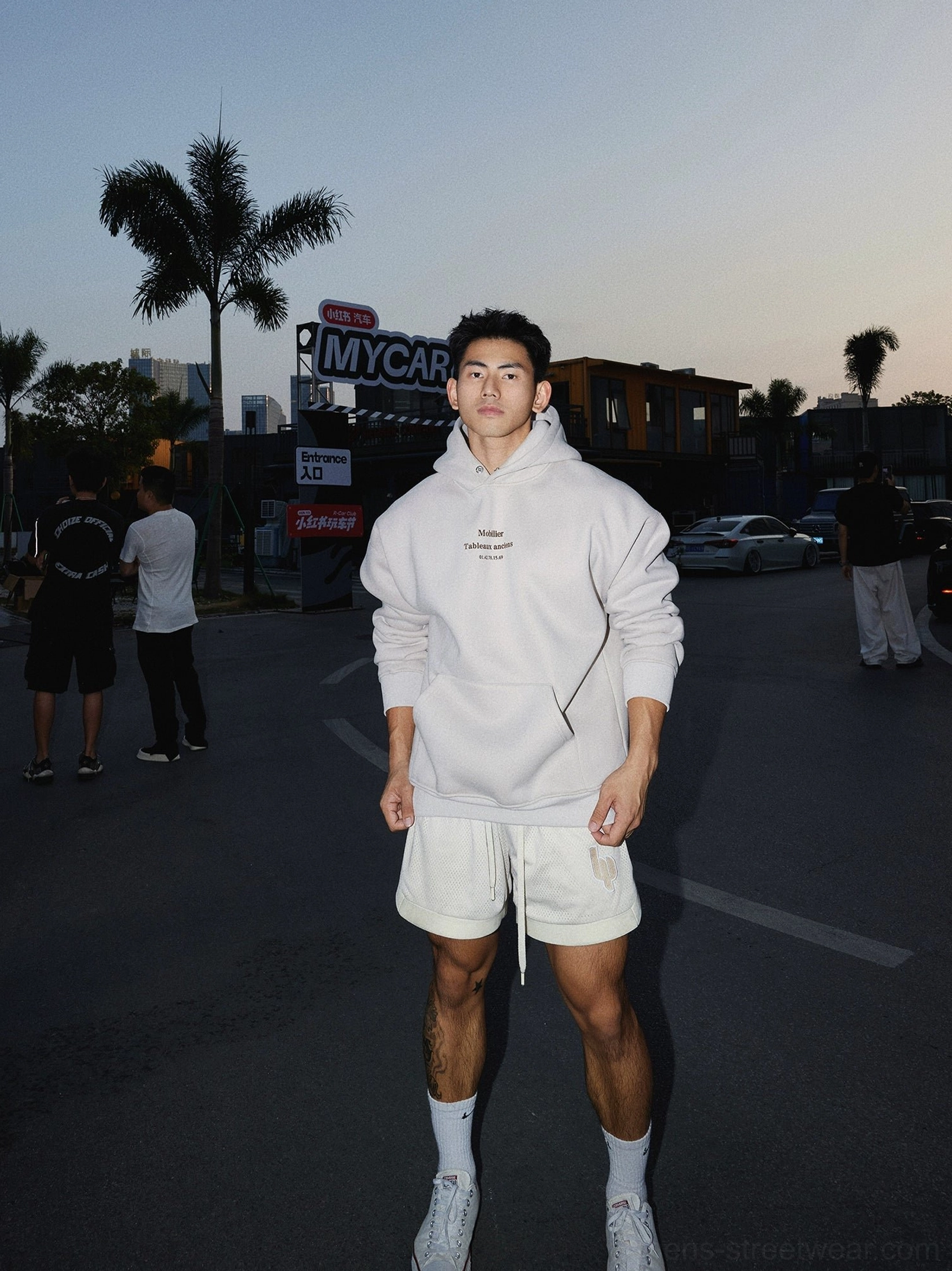 Apricot loose fit text graphic hoodie styled with athletic shorts and sneakers for casual Korean streetwear