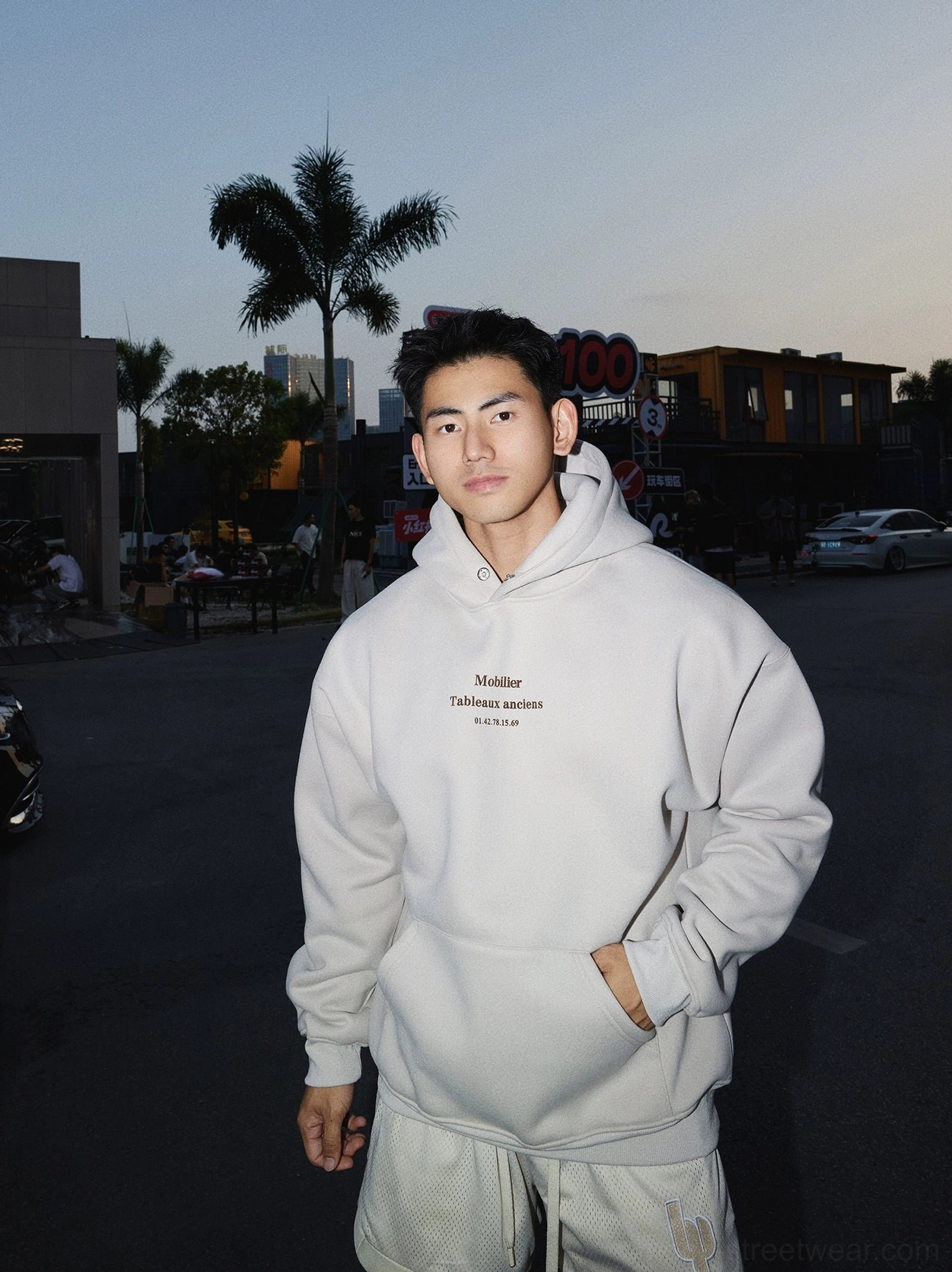 Apricot minimal graphic hoodie styled with matching sweatpants for a relaxed monochrome streetwear outfit