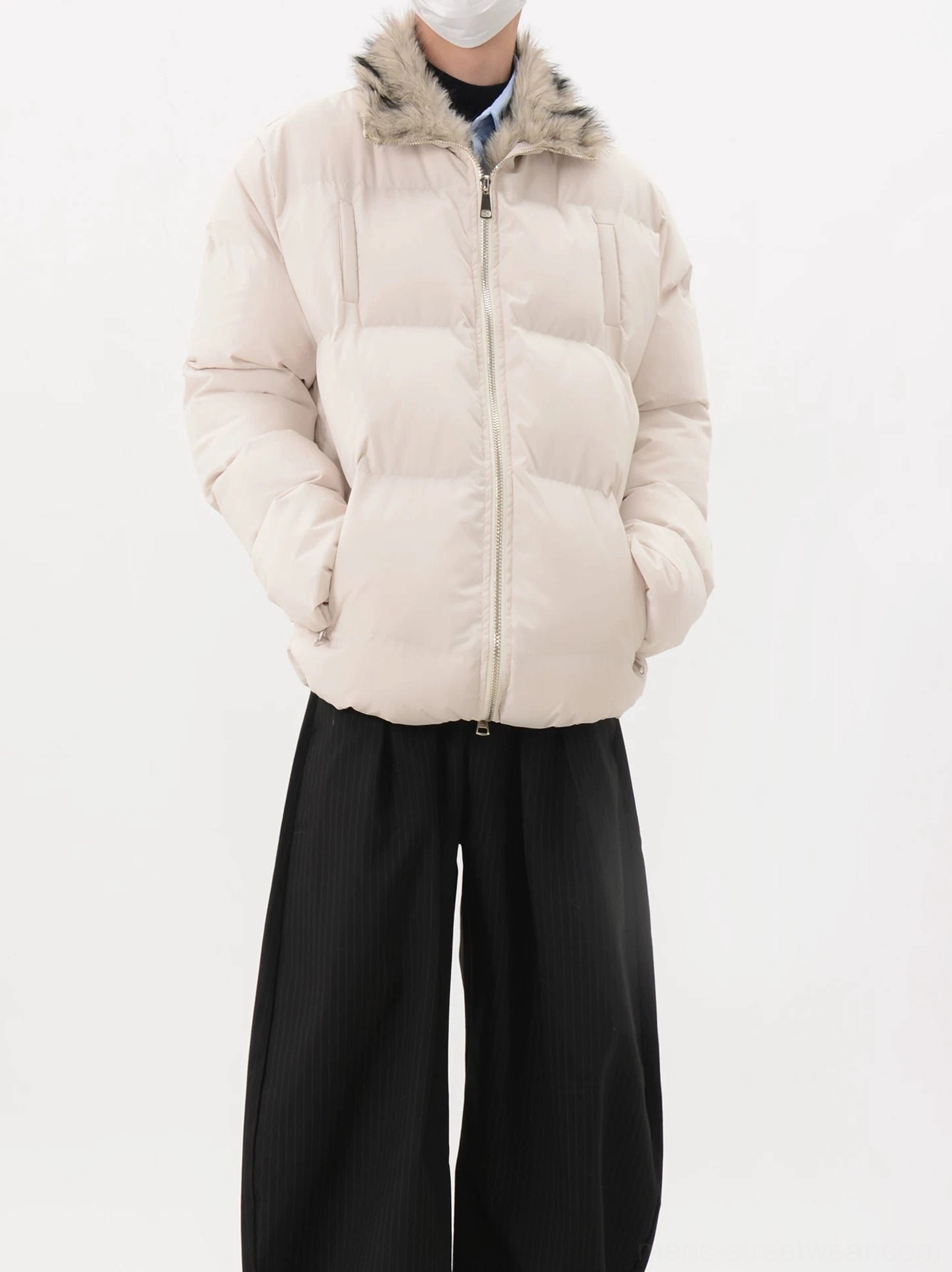 Apricot cream oversized faux fur collar puffer jacket with quilted construction, front zipper, and wide-leg black trousers