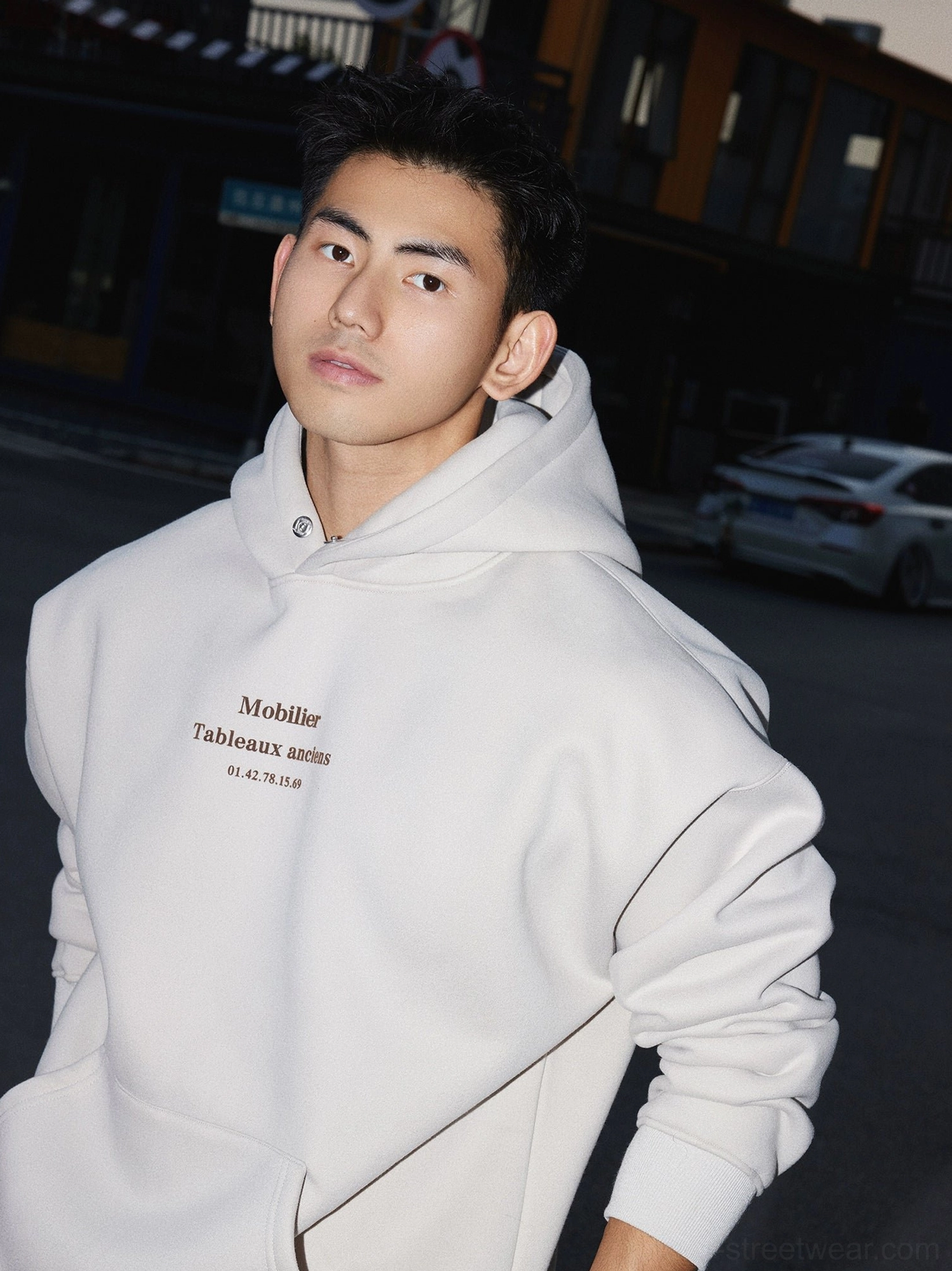 Apricot oversized text graphic hoodie shown from a three-quarter front angle in casual Seoul-inspired streetwear styling