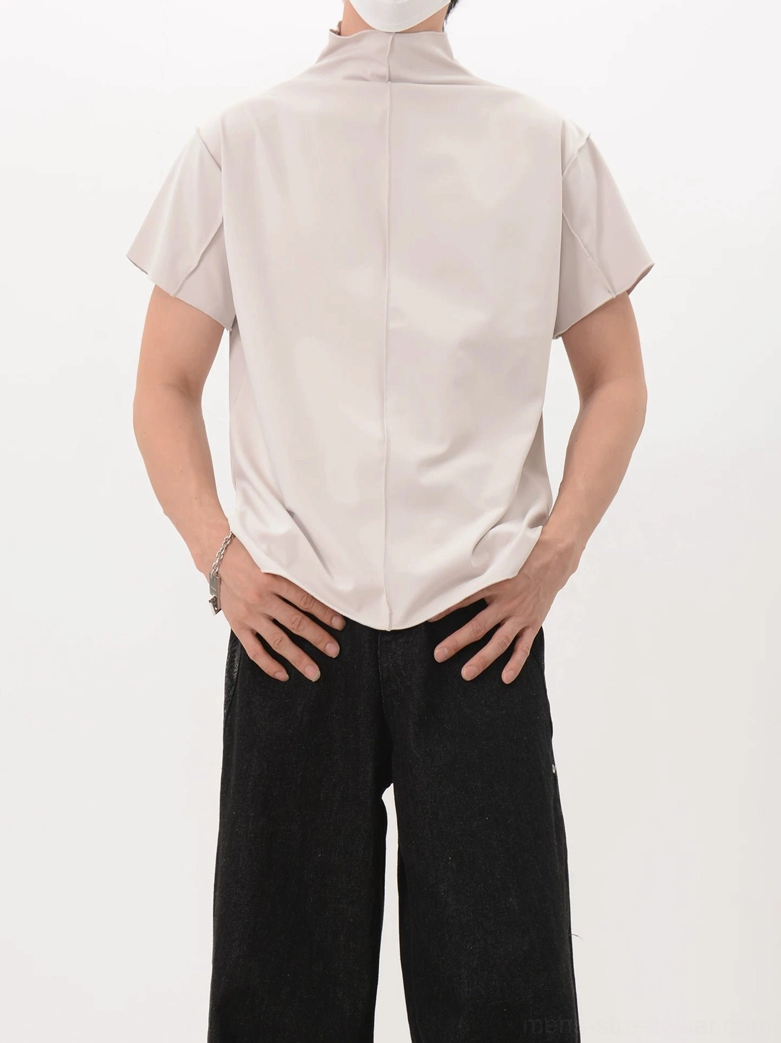 Three-quarter rear view of an apricot mock neck shirt with relaxed fit, curved hem, and minimalist Korean streetwear styling
