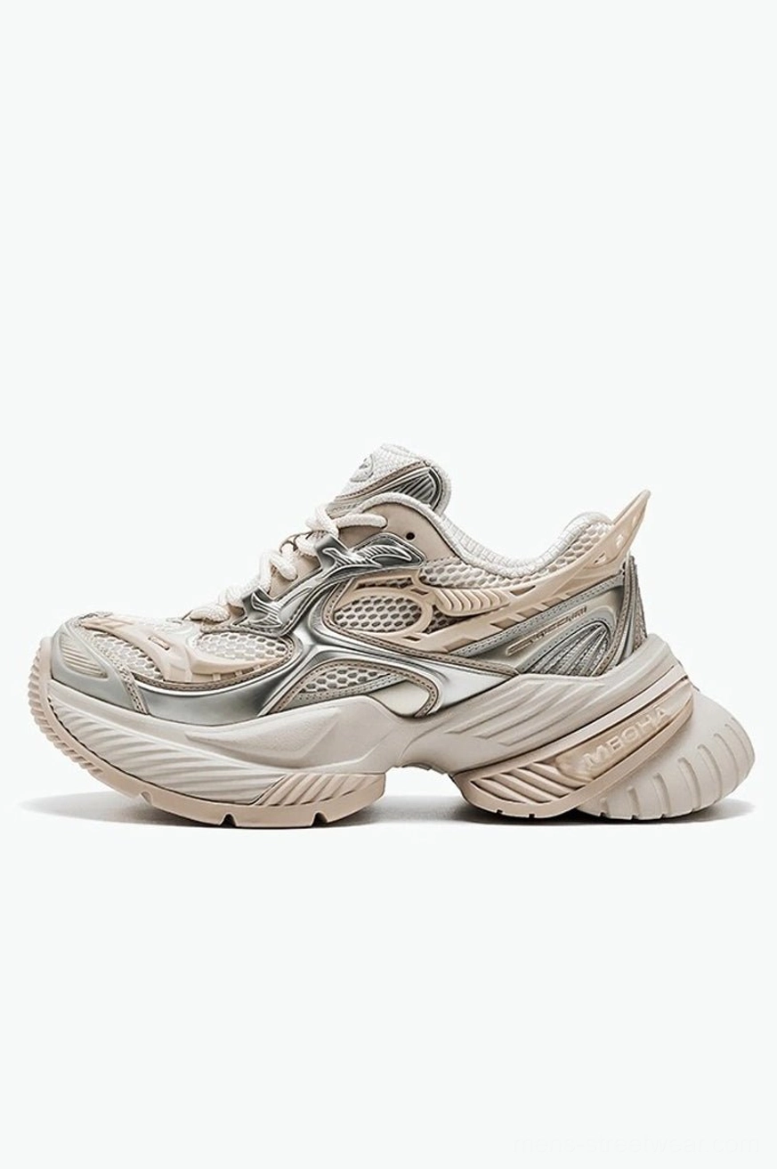 Light apricot and silver chunky platform sneakers viewed from the rear three-quarter angle with mesh and synthetic panels
