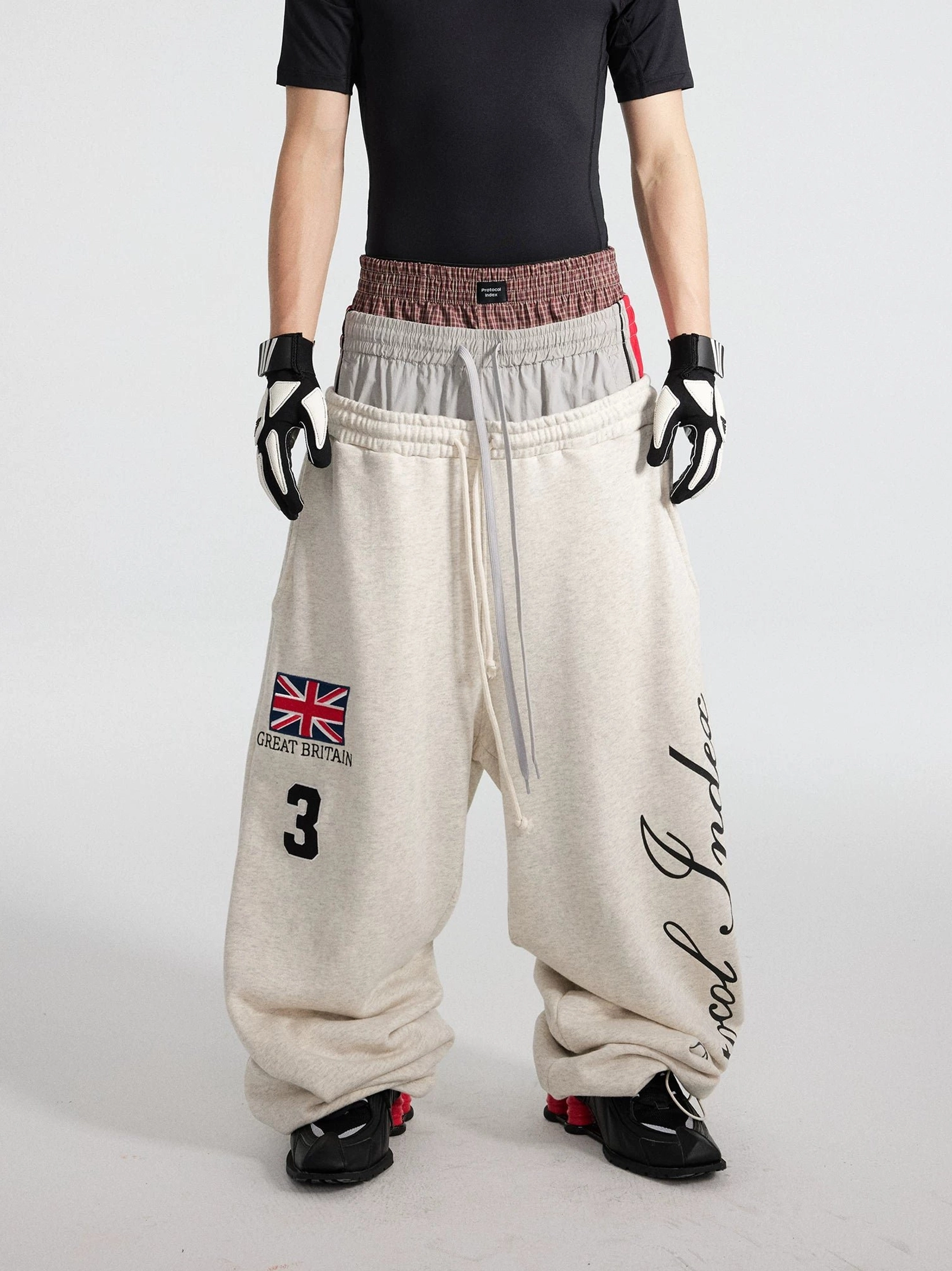 Apricot triple waist puddle track flares with contrast elastic bands graphic leg print and long drawcords front view