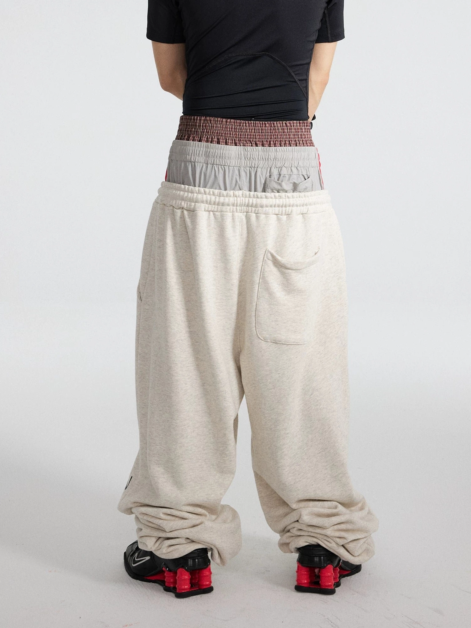 Apricot triple waist wide leg track flares rear view showing oversized fleece silhouette and layered elastic waist