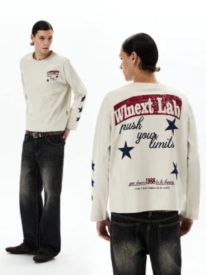 Apricot vintage graphic long sleeve streetwear tee shown from front and back with distressed retro print, navy star sleeve details, wide leg denim, and leather boots