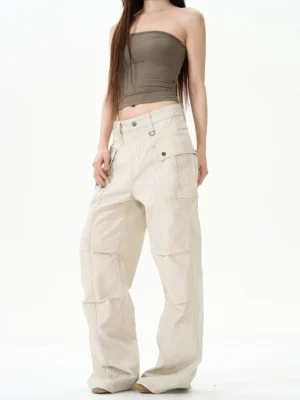 Front view of apricot vintage wide-leg cargo pants with multiple flap pockets and relaxed Korean streetwear silhouette on a female model