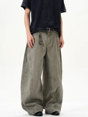 Cement ash ultra-wide washed denim balloon jeans front view with curved arc seam panels and oversized streetwear fit