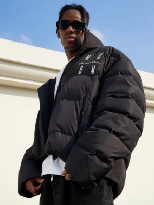 Black oversized duck-down puffer jacket worn in a relaxed Seoul streetwear outfit with quilted construction