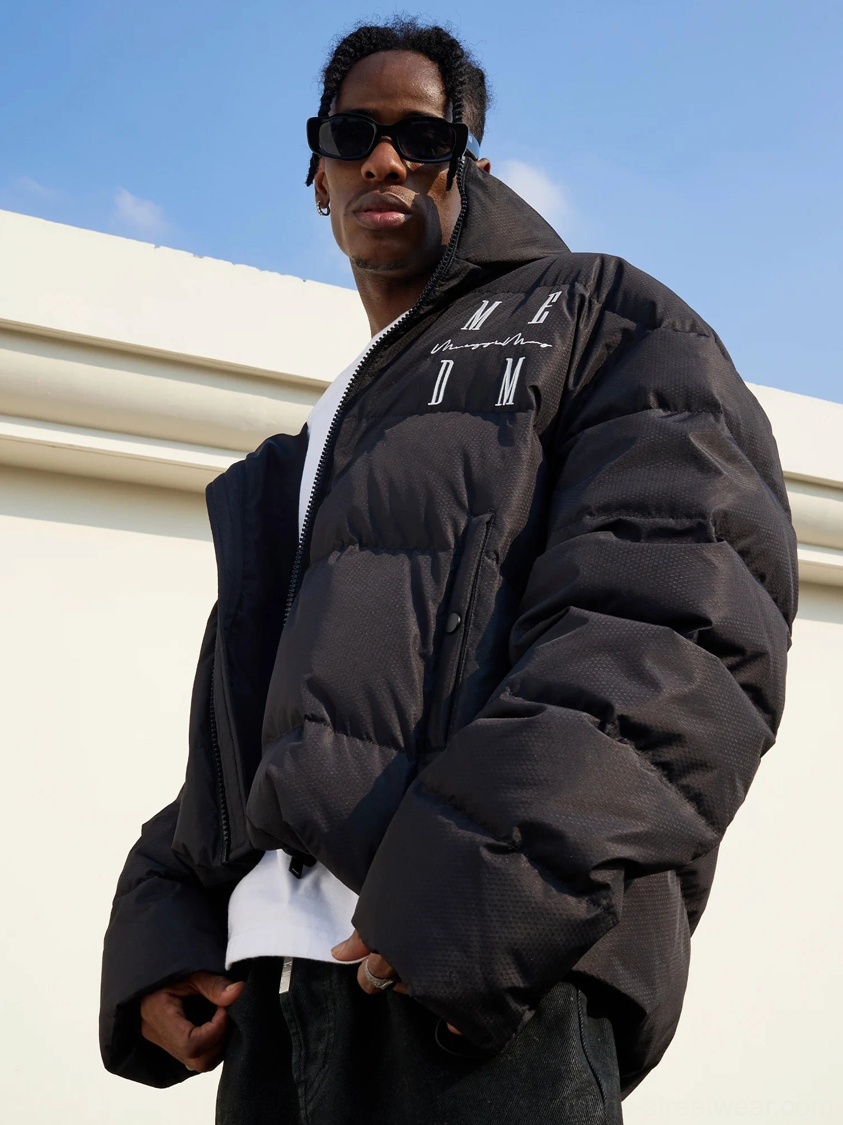 Black oversized duck-down puffer jacket worn in a relaxed Seoul streetwear outfit with quilted construction