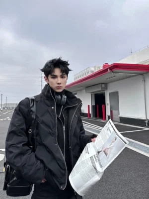 Black quilted down puffer jacket styled with layered clothing and shoulder bag on an urban street