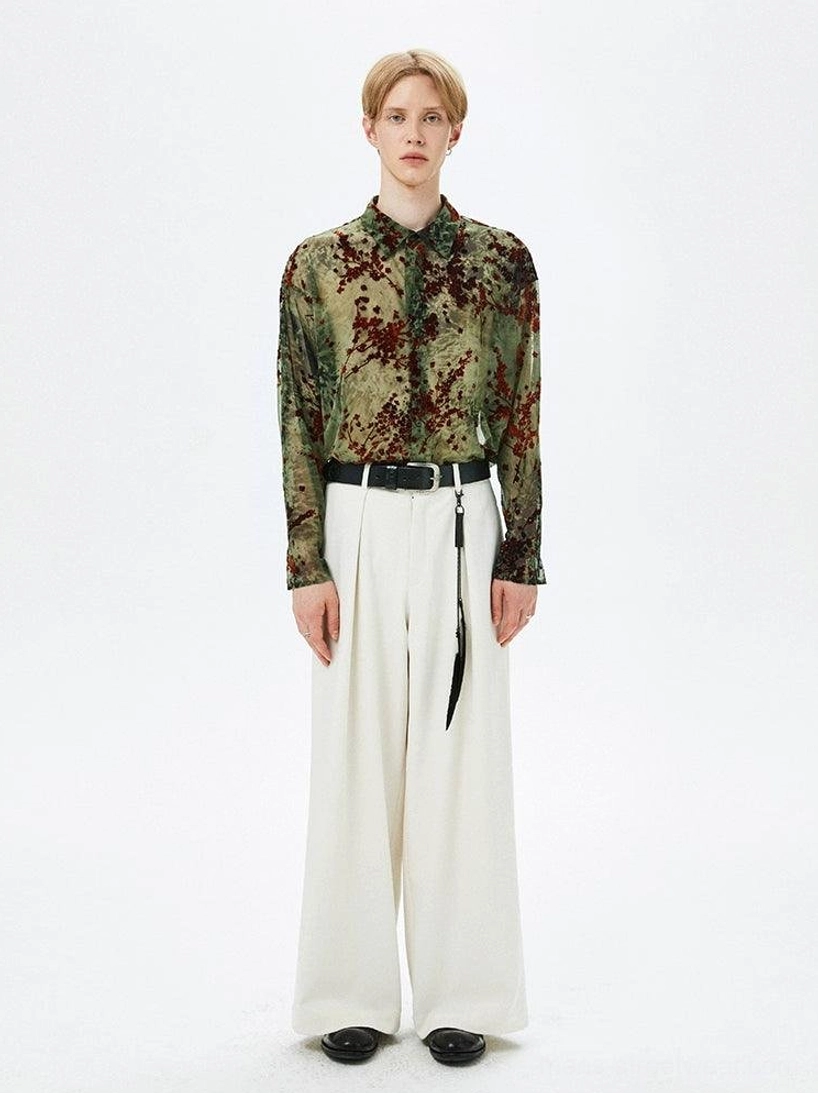 Full body outfit featuring an army green floral sheer button-up shirt tucked into high-waisted white wide-leg pants