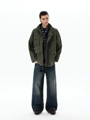 Army green Korean streetwear field jacket with stand collar and multiple flap cargo pockets shown in a relaxed full-body outfit
