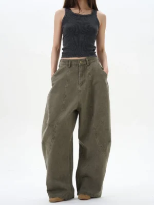 Female model wearing army green oversized pleated wide leg denim pants with high waist and curved seam details in Korean streetwear style