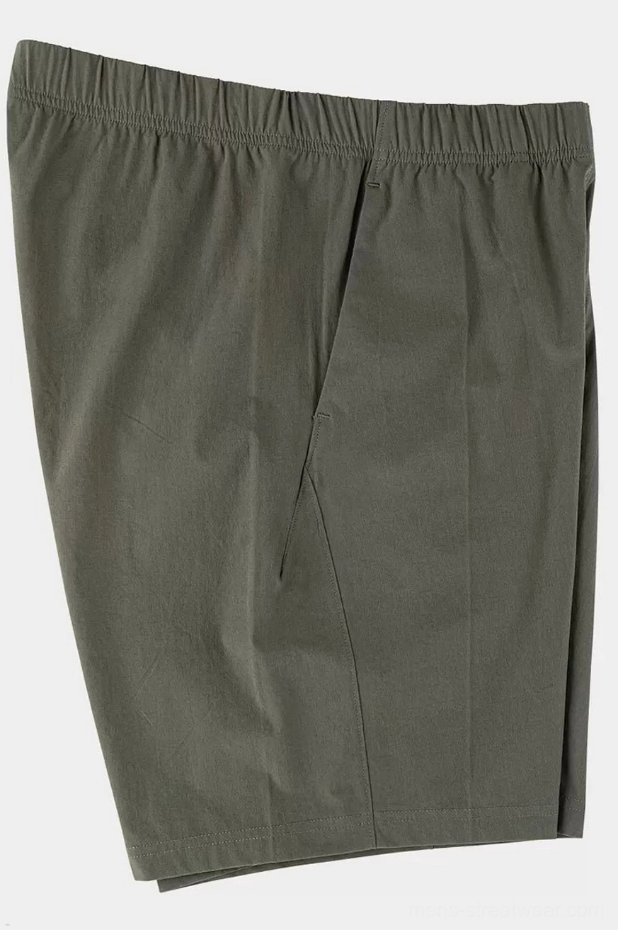 Army green oversized tech shorts side three-quarter flat lay showing relaxed straight leg and lightweight drape