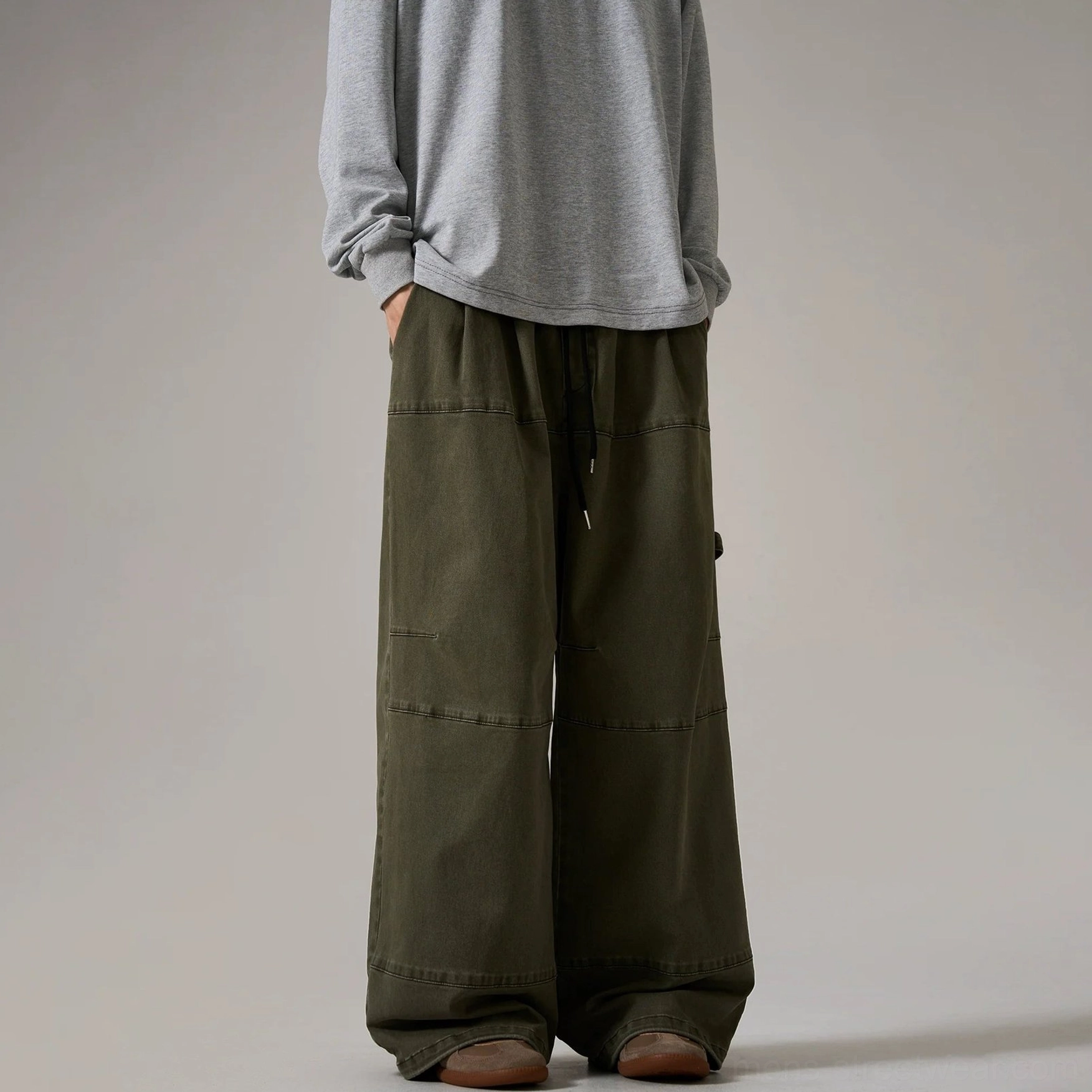 Army green wide-leg cargo skater pants with drawstring waistband, contrast topstitching, side cargo loop, and relaxed utility streetwear design